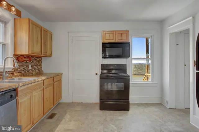 a kitchen with stainless steel appliances granite countertop a refrigerator and a stove