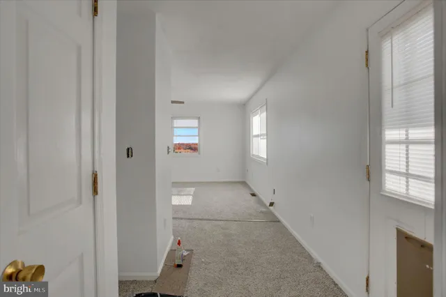 an entryway to room with windows