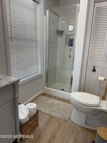 a bathroom with a toilet and a shower