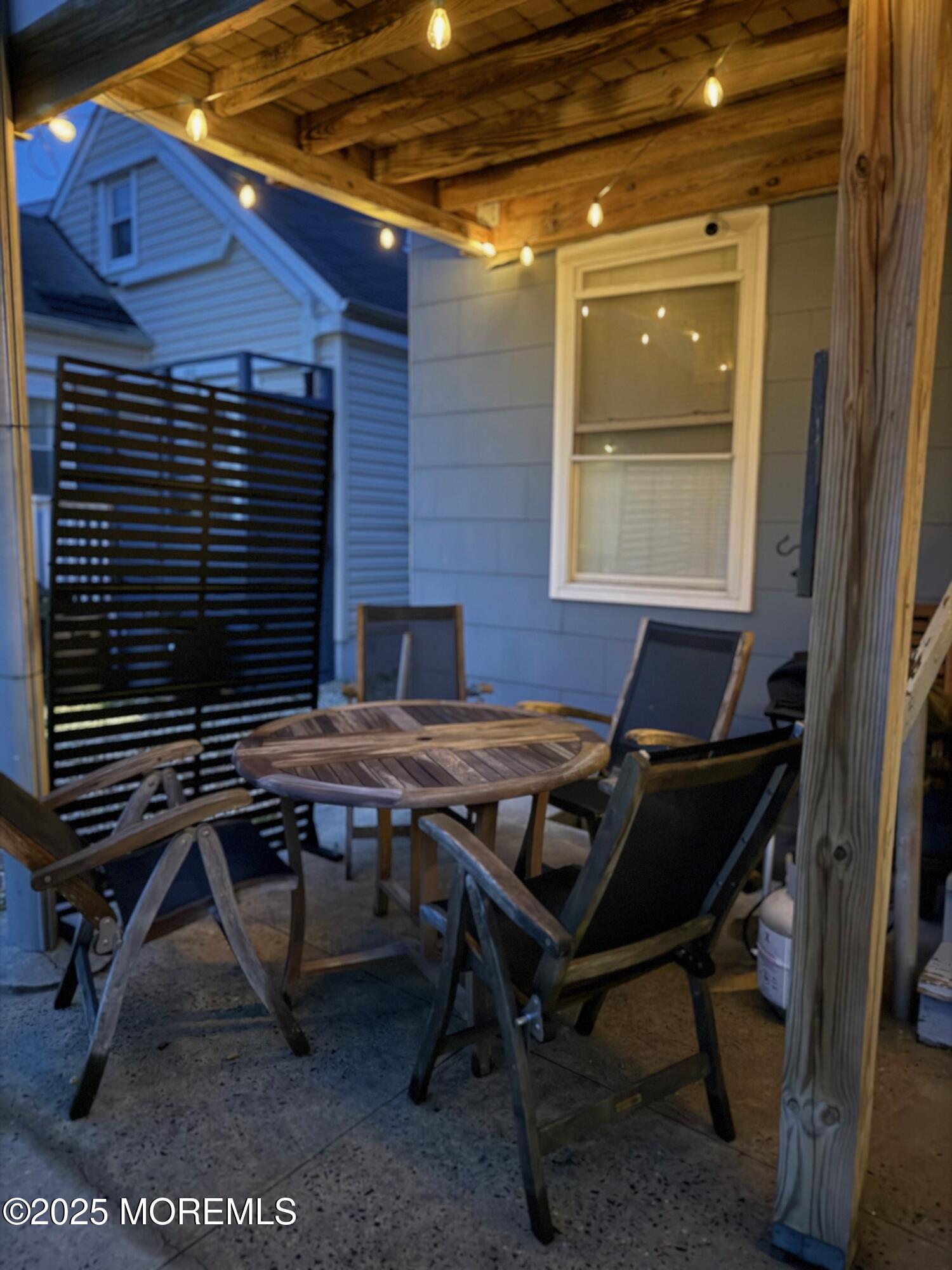 191 3rd Avenue, Unit 1 Manasquan, NJ 08736 - Photo 3 of 13 a backyard of a house with table and chairs
