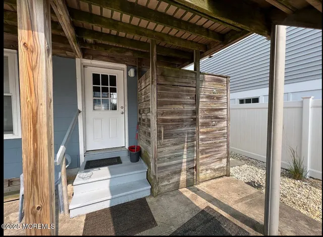 a view of porch with a door and wooden floor