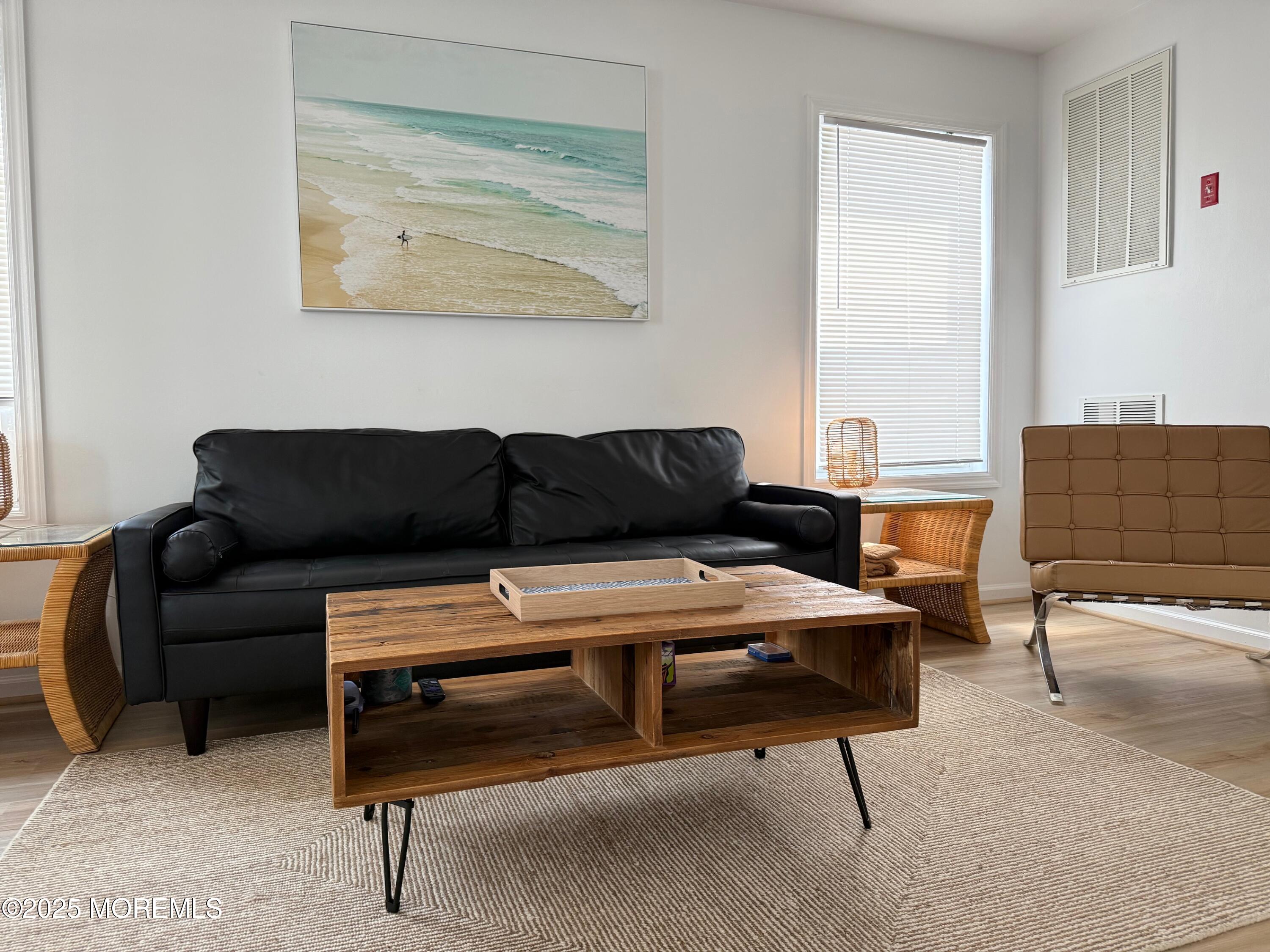 191 3rd Avenue, Unit 1 Manasquan, NJ 08736 - Photo 7 of 13 a living room with furniture and a couch