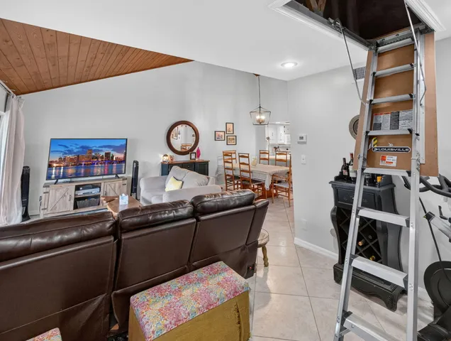 a living room with lots of furniture and clutter on the wall