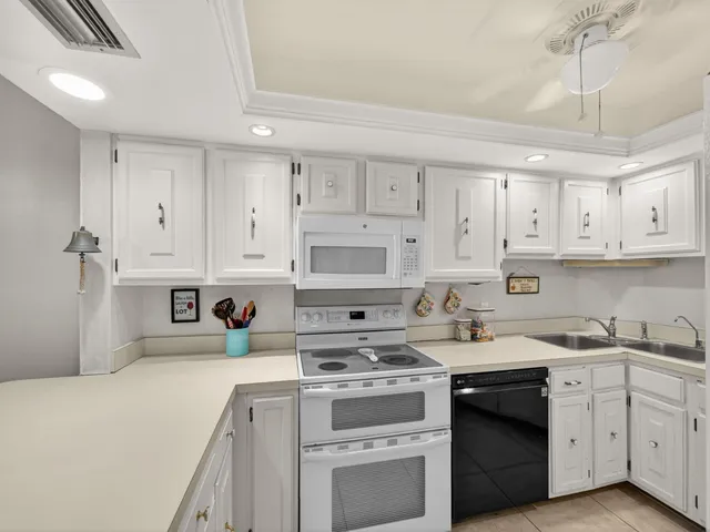 a kitchen with stainless steel appliances granite countertop a sink a stove and cabinets