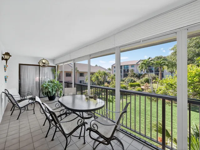 a view of a chairs and table in the balcony