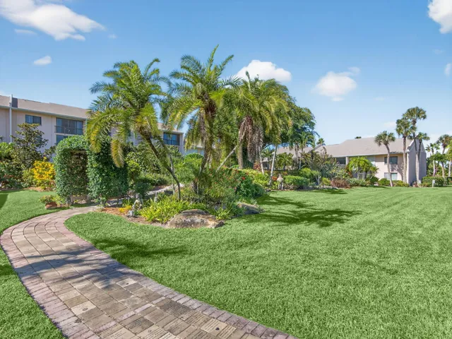 a view of a garden with a building in the background