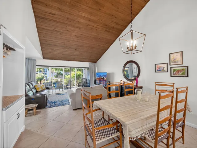 a view of a dining room with furniture a chandelier and wooden floor