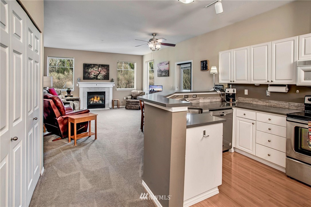 17426 Bothell Way Northeast, Unit A402 Bothell, WA 98011 - Photo 11 of 29 a kitchen with a stove a sink and a refrigerator