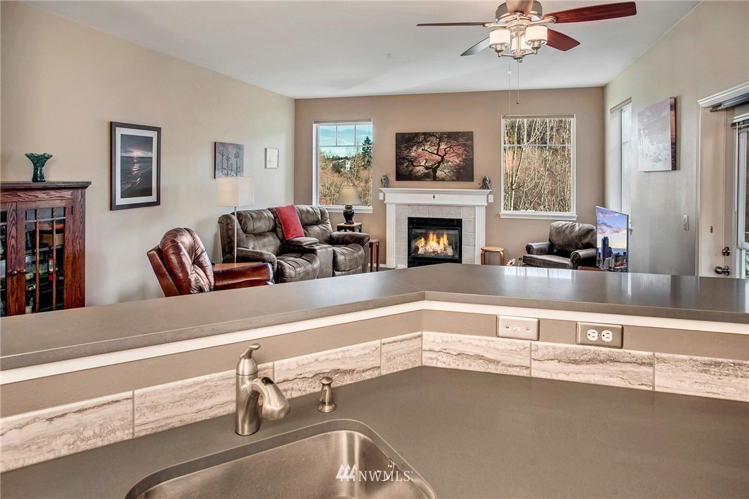 17426 Bothell Way Northeast, Unit A402 Bothell, WA 98011 - Photo 14 of 29 a living room with furniture and a fireplace