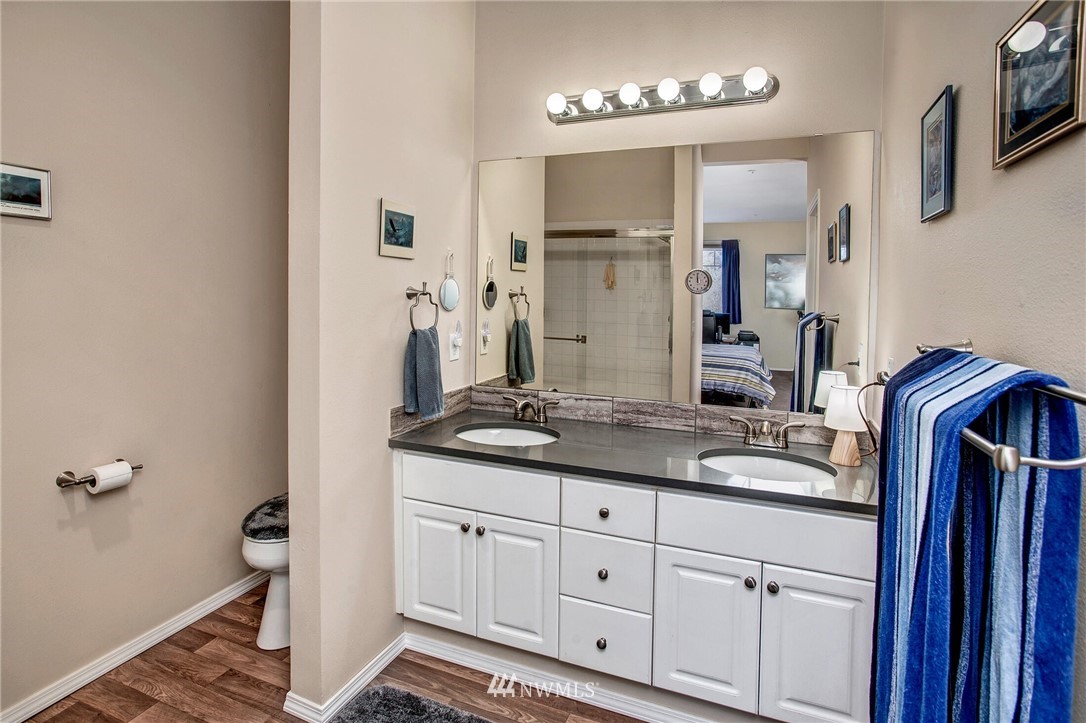 17426 Bothell Way Northeast, Unit A402 Bothell, WA 98011 - Photo 20 of 29 a bathroom with a granite countertop double vanity sink and mirror