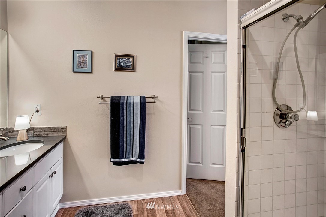 17426 Bothell Way Northeast, Unit A402 Bothell, WA 98011 - Photo 21 of 29 a bathroom with a granite countertop shower a sink and mirror