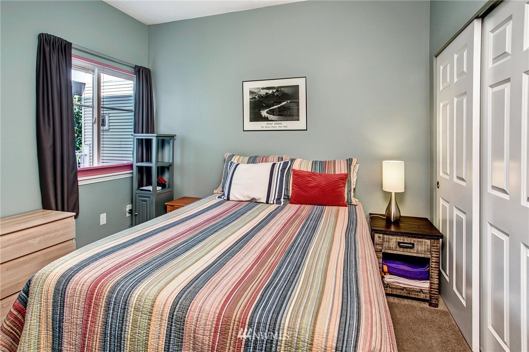 17426 Bothell Way Northeast, Unit A402 Bothell, WA 98011 - Photo 22 of 29 a bedroom with a bed and a window