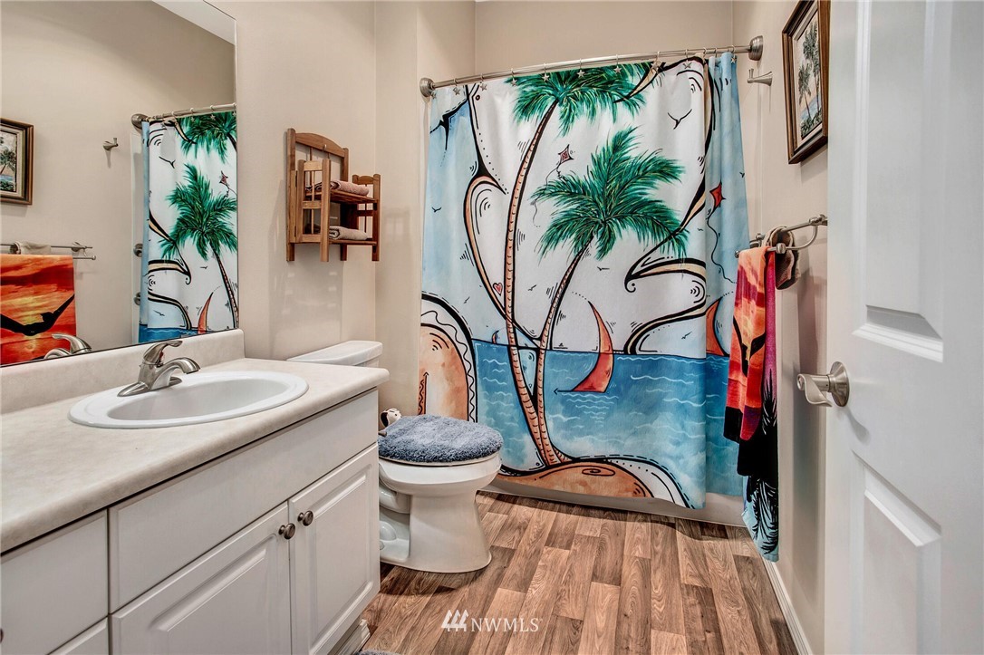 17426 Bothell Way Northeast, Unit A402 Bothell, WA 98011 - Photo 23 of 29 a bathroom with a sink a mirror and a toilet