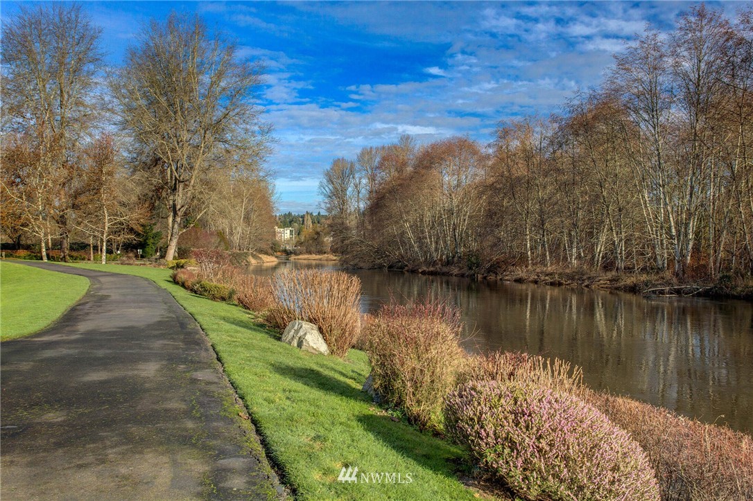 17426 Bothell Way Northeast, Unit A402 Bothell, WA 98011 - Photo 5 of 29 a view of a lake with a yard and large trees