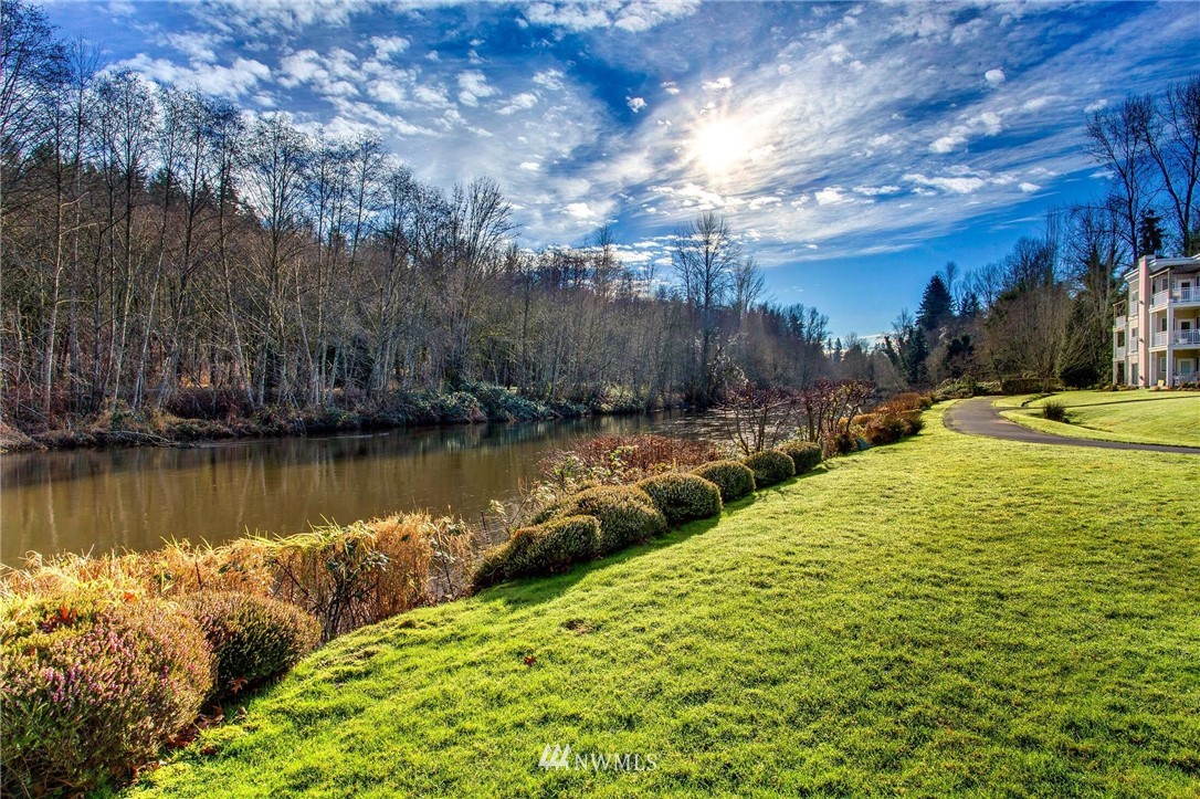 17426 Bothell Way Northeast, Unit A402 Bothell, WA 98011 - Photo 6 of 29 a view of a lake with a yard