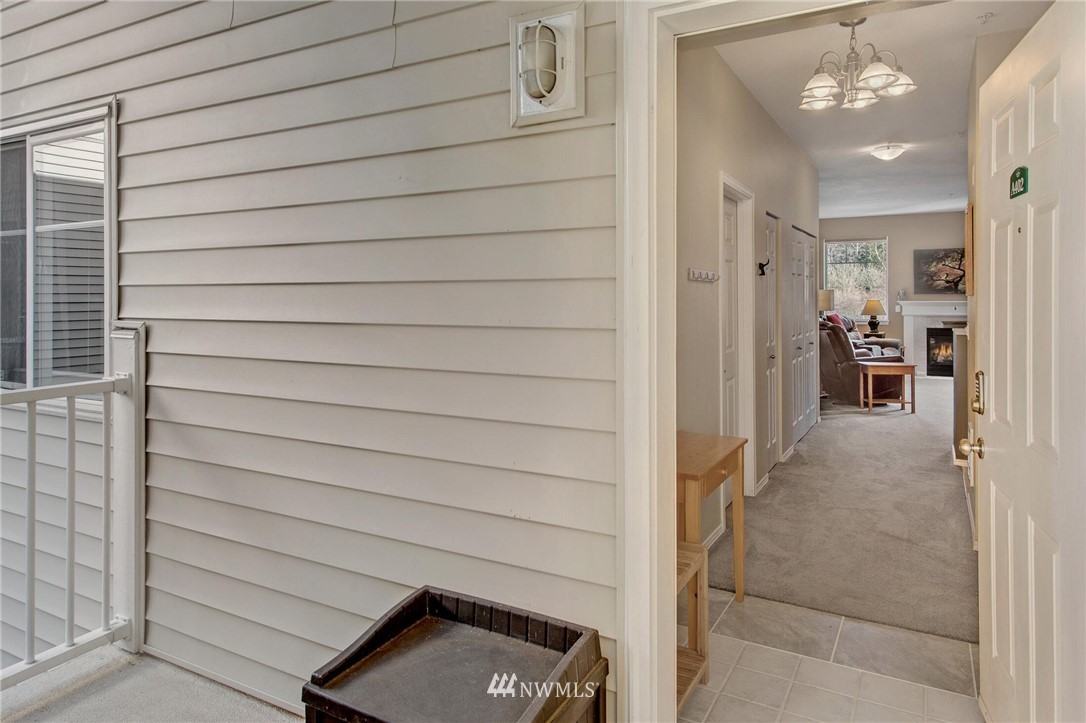 17426 Bothell Way Northeast, Unit A402 Bothell, WA 98011 - Photo 8 of 29 a view of a door and chair in the balcony