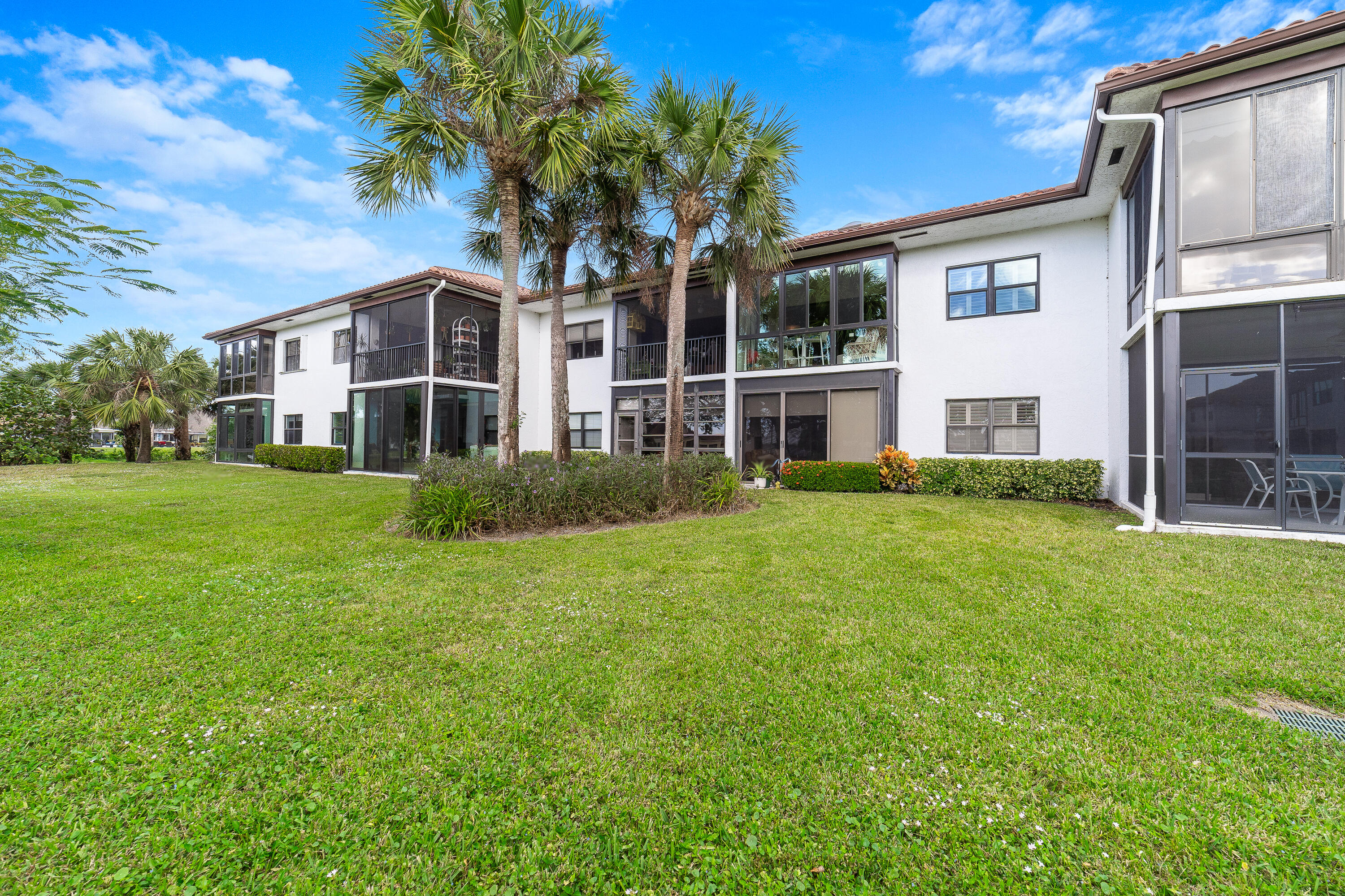 6121 Southeast Landing Way, Unit 12 Stuart, FL 34997 - Photo 1 of 47 a front view of a house with a yard