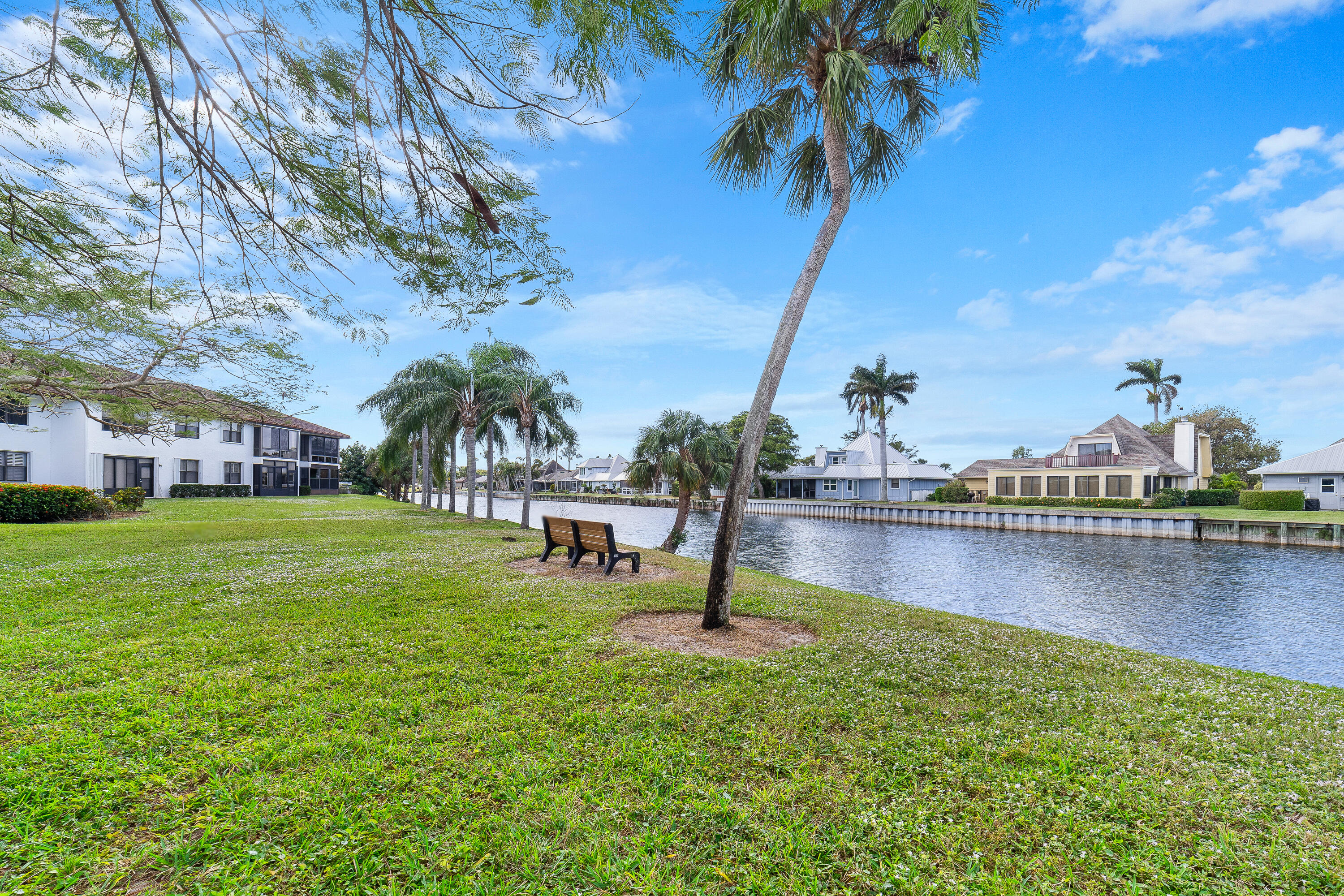 6121 Southeast Landing Way, Unit 12 Stuart, FL 34997 - Photo 13 of 47 a swimming pool with outdoor seating and garden