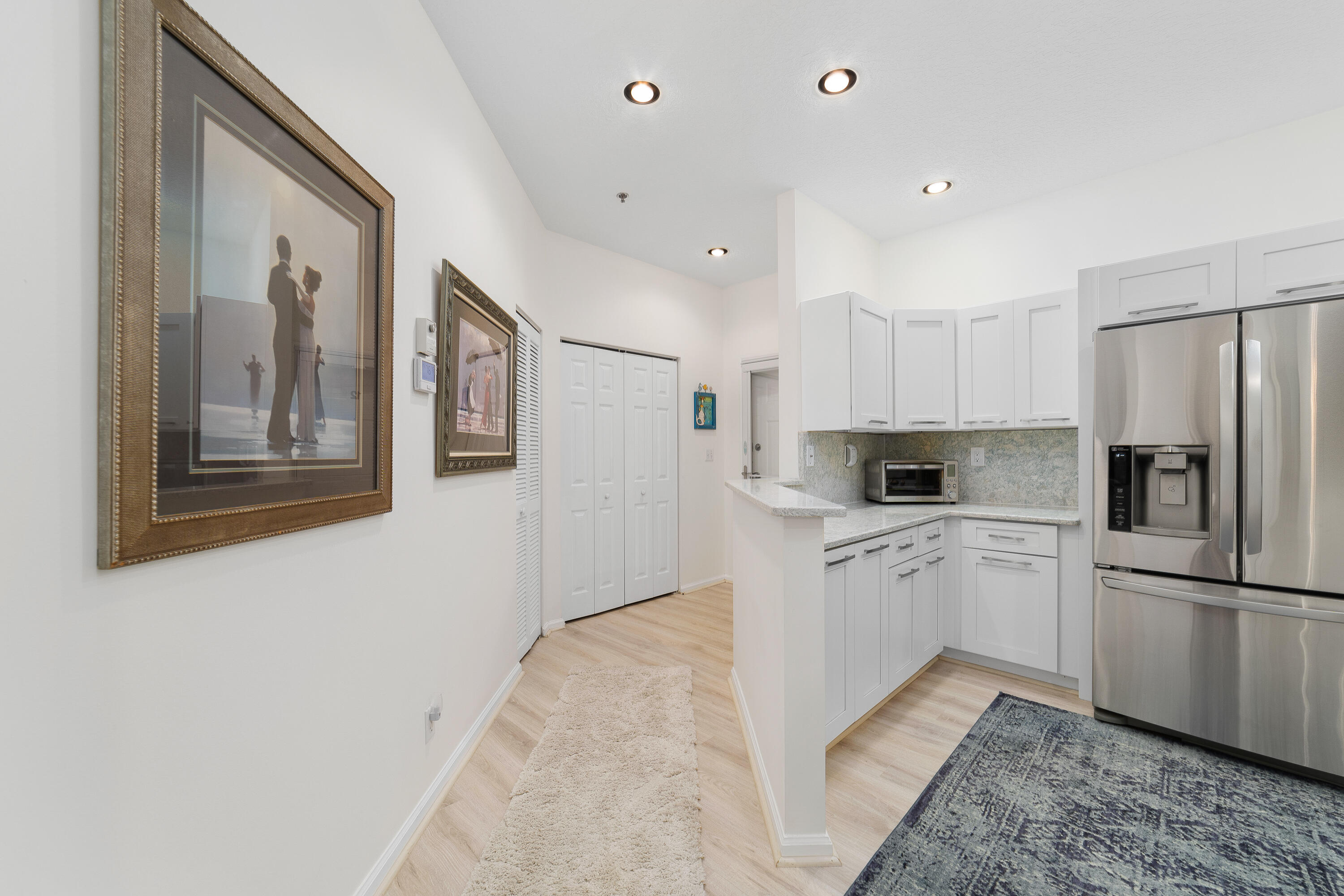 6121 Southeast Landing Way, Unit 12 Stuart, FL 34997 - Photo 14 of 47 a kitchen with stainless steel appliances granite countertop a refrigerator and a stove top oven