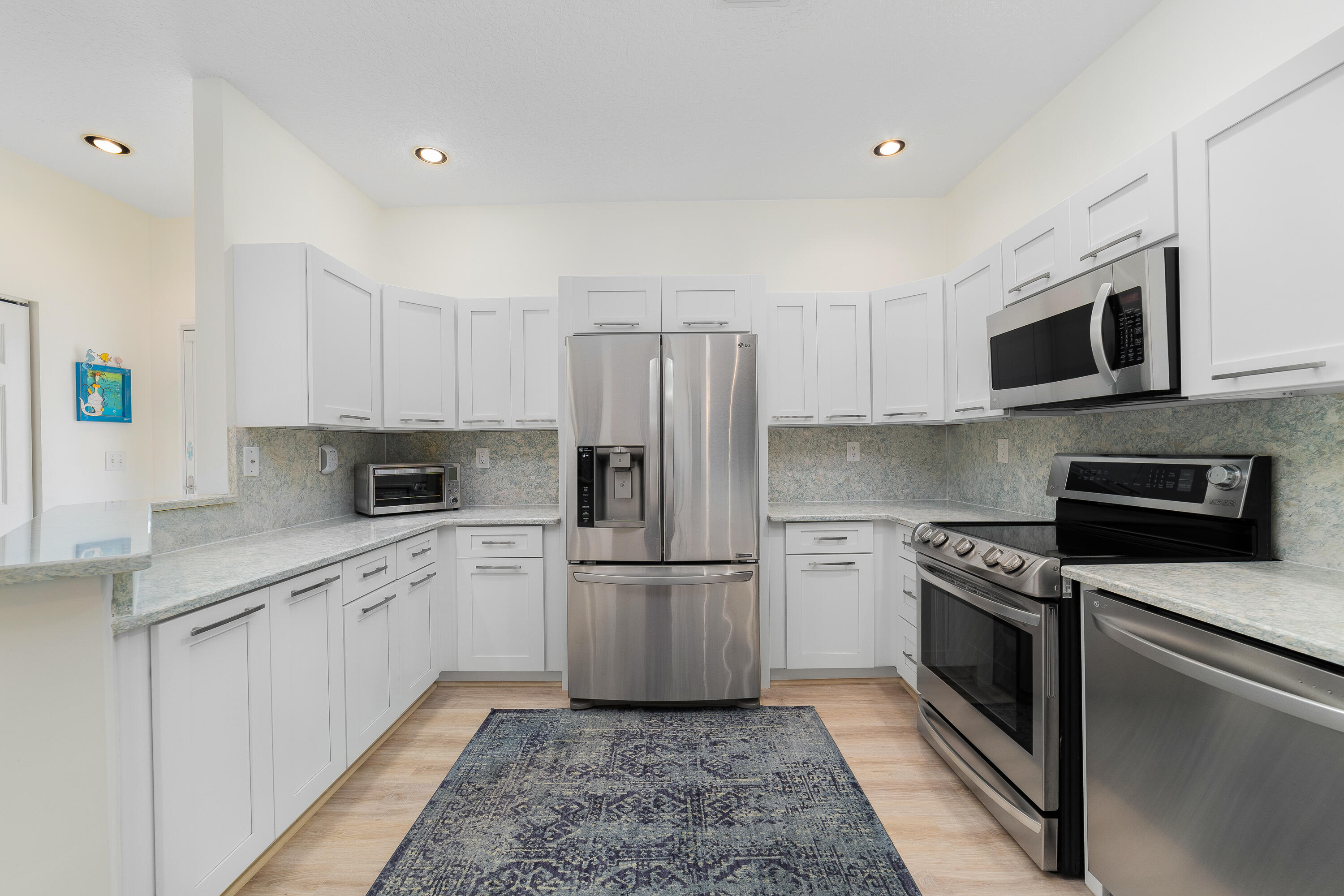 6121 Southeast Landing Way, Unit 12 Stuart, FL 34997 - Photo 15 of 47 a kitchen with a sink microwave and refrigerator