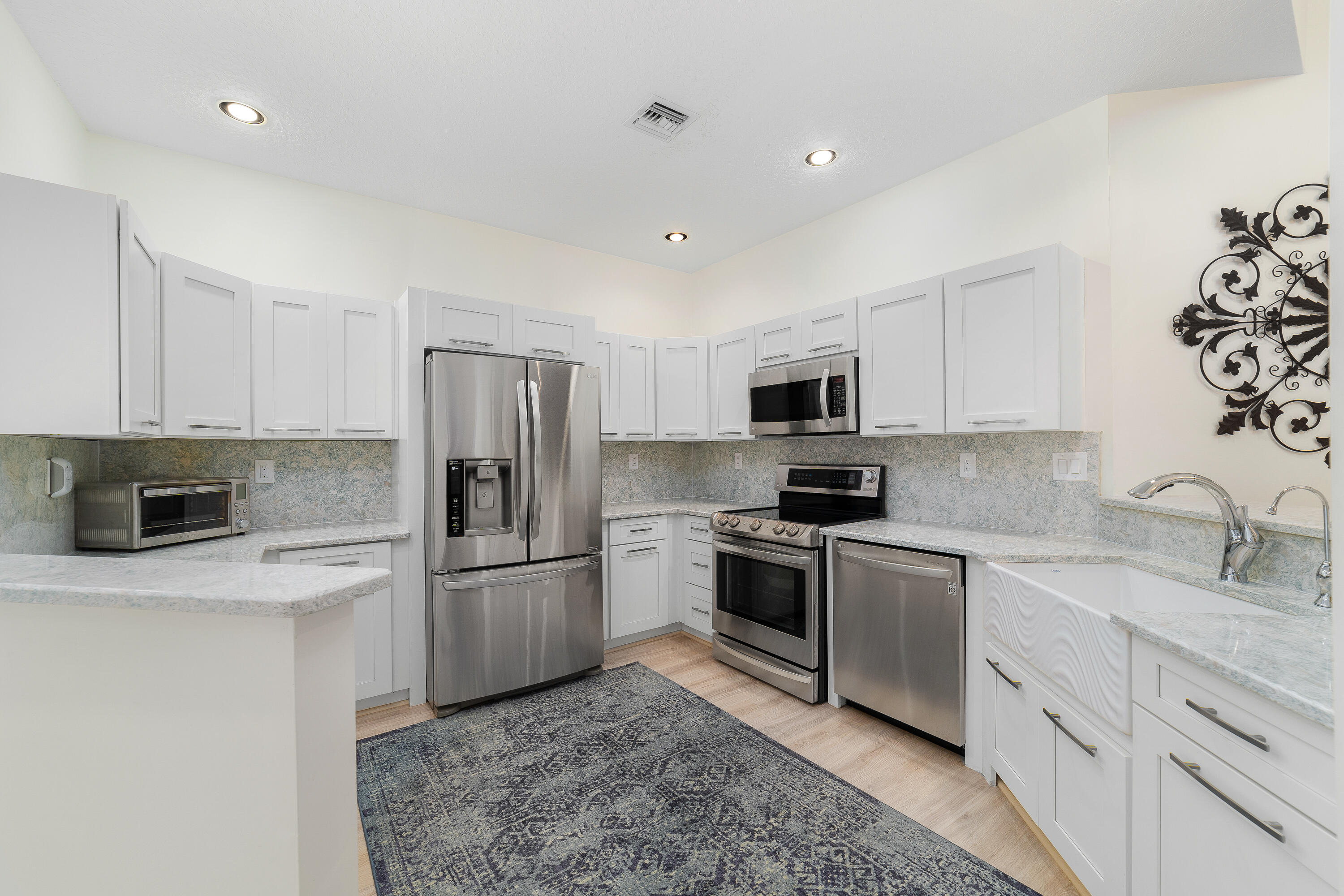 6121 Southeast Landing Way, Unit 12 Stuart, FL 34997 - Photo 16 of 47 a kitchen with a sink stove and refrigerator