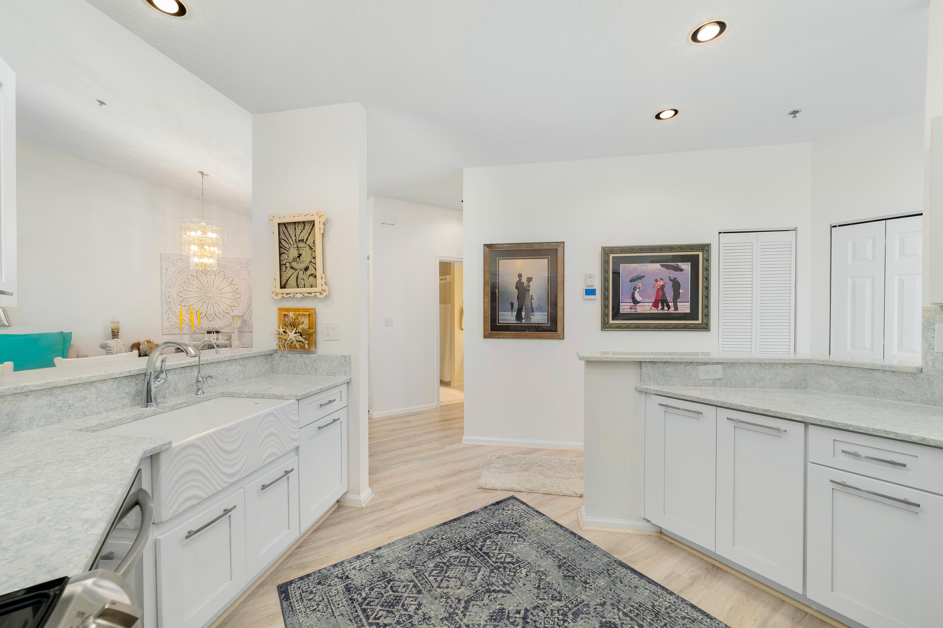 6121 Southeast Landing Way, Unit 12 Stuart, FL 34997 - Photo 18 of 47 a spacious bathroom with a granite countertop sink and a mirror