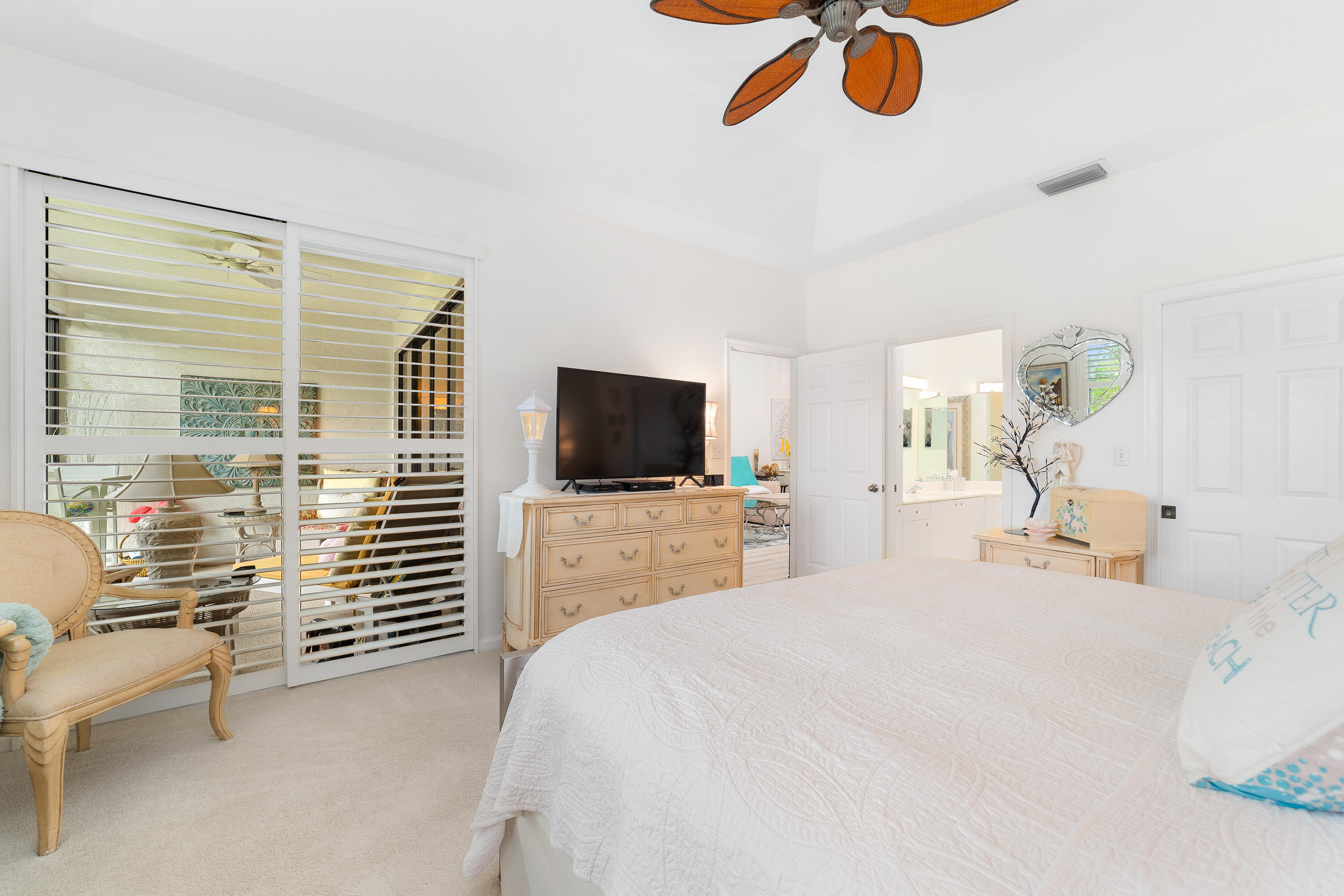6121 Southeast Landing Way, Unit 12 Stuart, FL 34997 - Photo 21 of 47 a bedroom with a bed and a flat screen tv