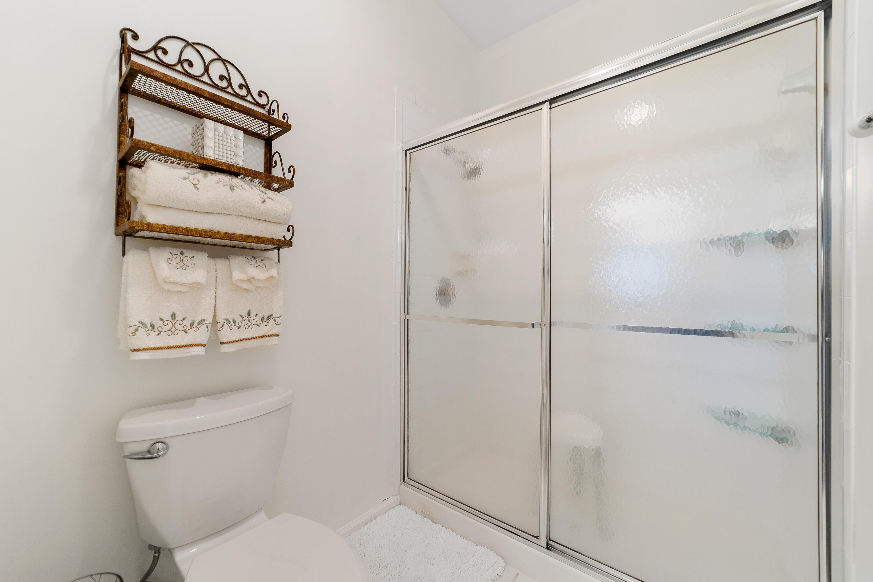 6121 Southeast Landing Way, Unit 12 Stuart, FL 34997 - Photo 25 of 47 a bathroom with a shower a toilet and a sink