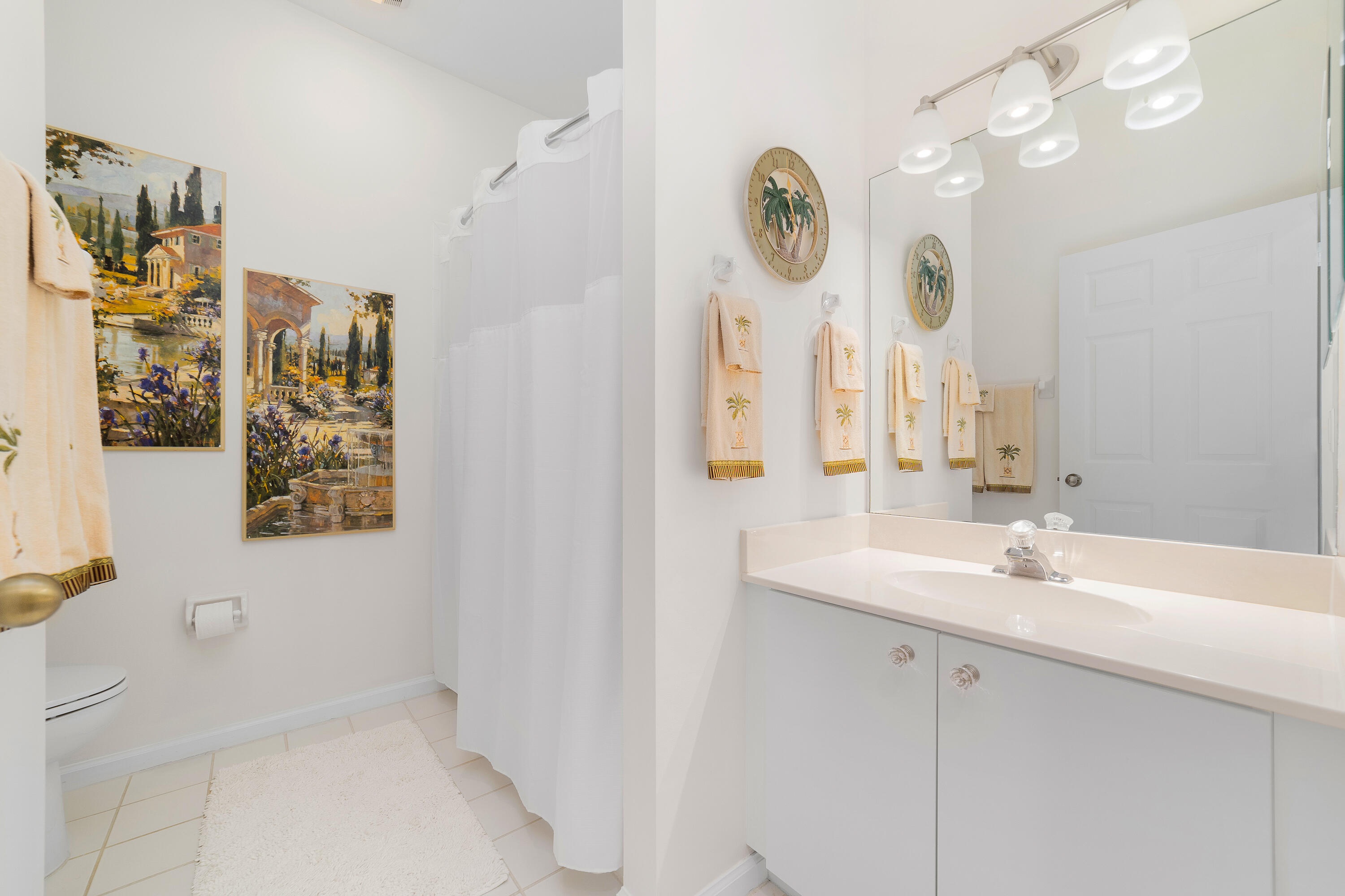 6121 Southeast Landing Way, Unit 12 Stuart, FL 34997 - Photo 28 of 47 a bathroom with a sink a mirror and a shower