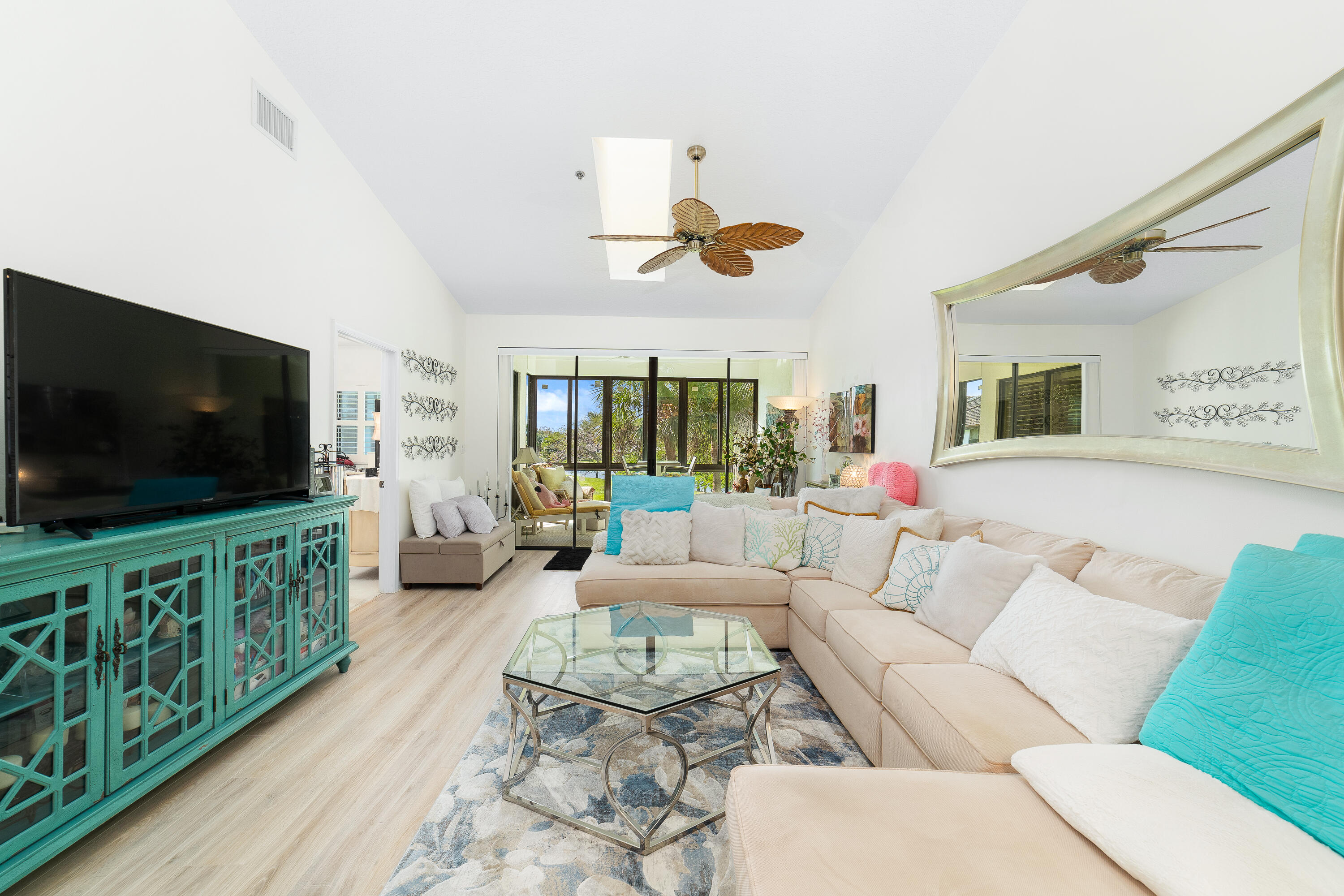 6121 Southeast Landing Way, Unit 12 Stuart, FL 34997 - Photo 4 of 47 a living room with furniture and a flat screen tv
