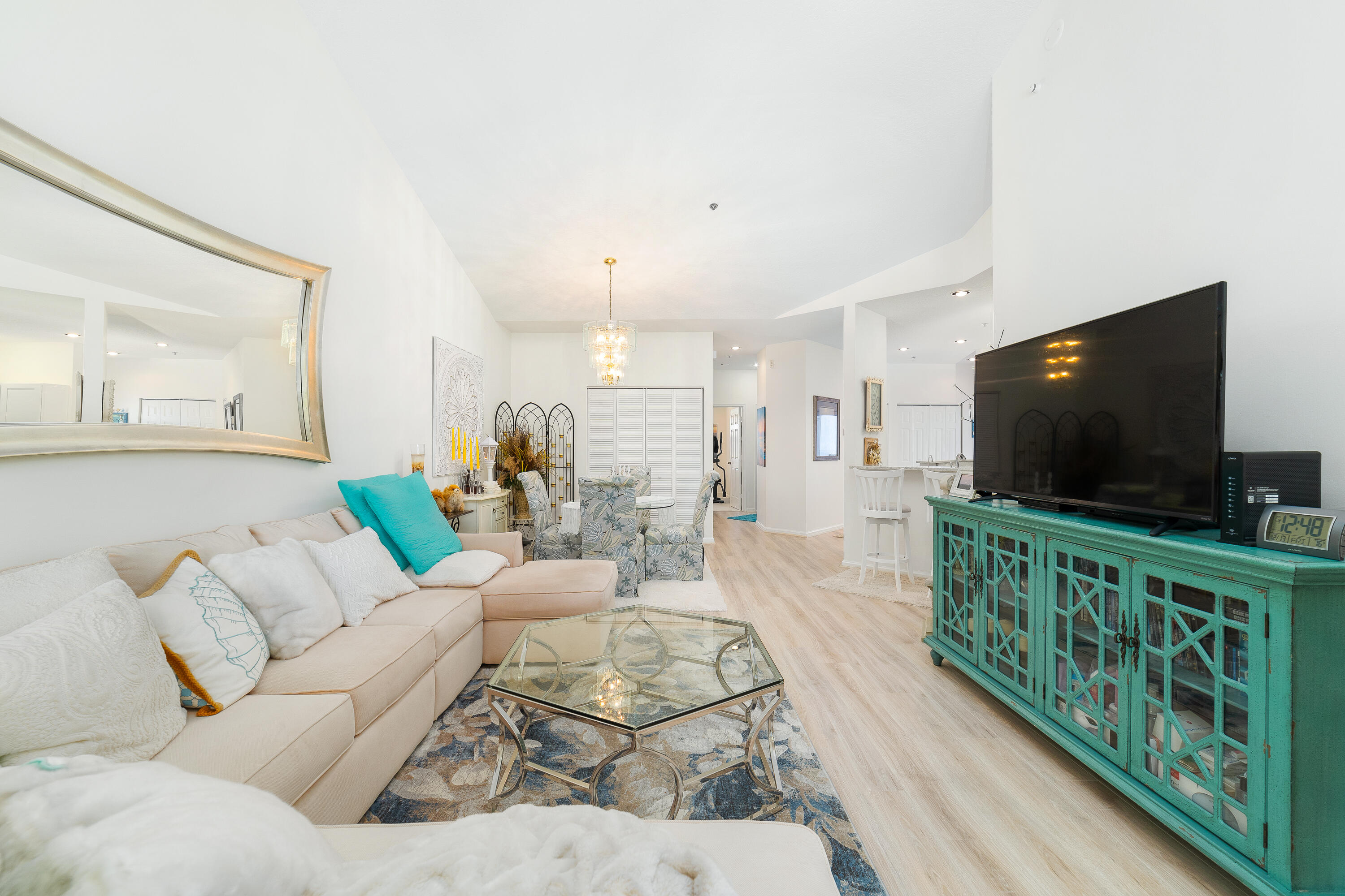 6121 Southeast Landing Way, Unit 12 Stuart, FL 34997 - Photo 6 of 47 a living room with furniture and a flat screen tv