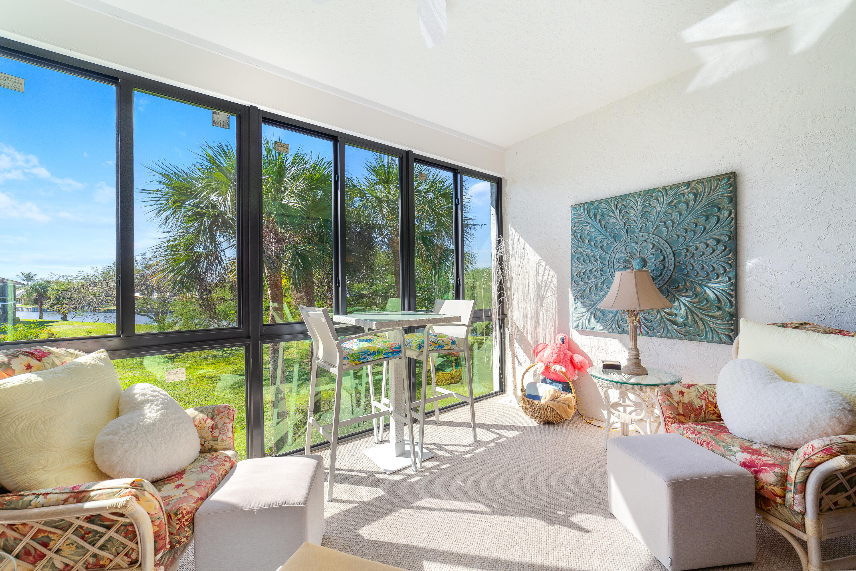 6121 Southeast Landing Way, Unit 12 Stuart, FL 34997 - Photo 10 of 47 a living room filled with furniture and a floor to ceiling window