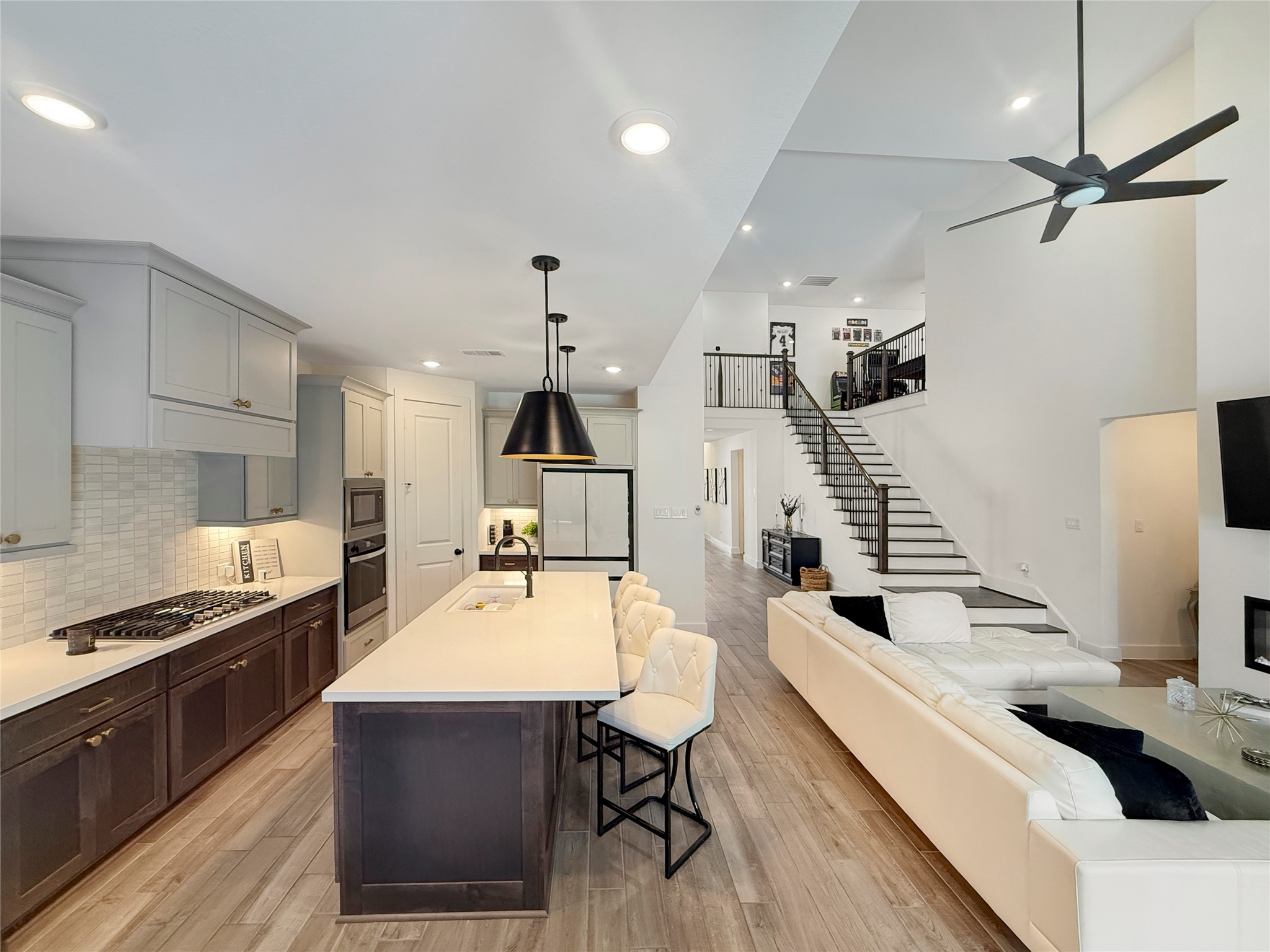 26918 Swanborough Road Spring, TX 77389 - Photo 17 of 50 Kitchen features island seating, sleek countertops, cabinetry, High end appliances, all complemented by statement pendant lighting and abundant natural light.