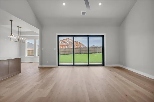 a view of kitchen with kitchen island wooden floor center island and stainless steel appliances