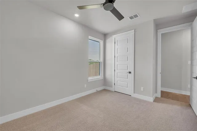 a view of room with window and ceiling fan
