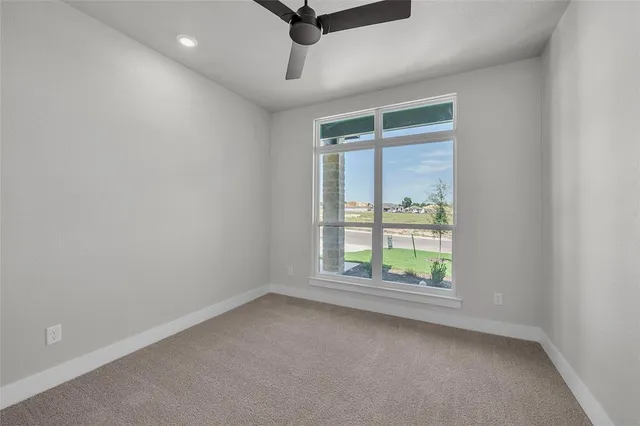 a bathroom with a bathtub shower sink vanity mirror and toilet