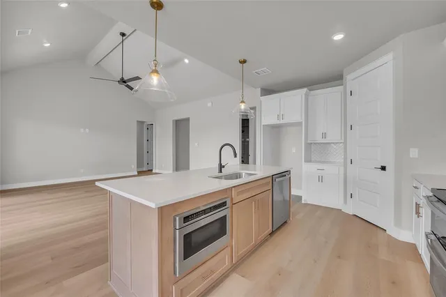 a kitchen that has a sink and a stove