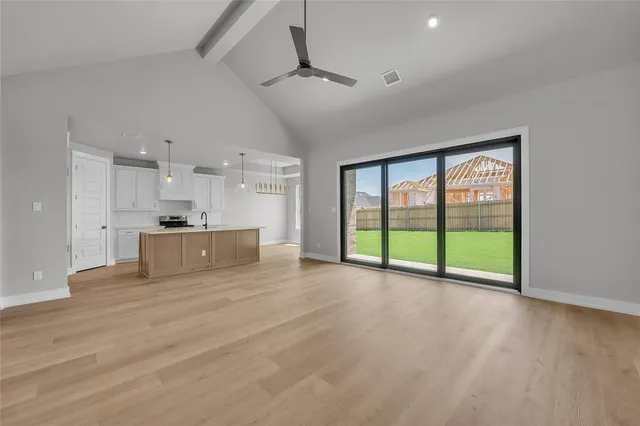 a kitchen with kitchen island a sink stainless steel appliances and cabinets
