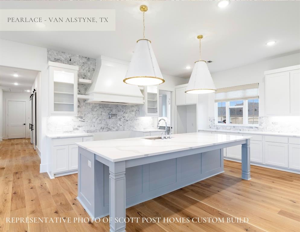 Tbd Lot 9 Tbd Van Alstyne, TX 75495 - Photo 8 of 19 a large kitchen with kitchen island a sink stainless steel appliances and cabinets