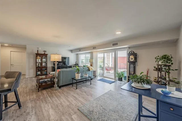 a living room with furniture and a potted plant