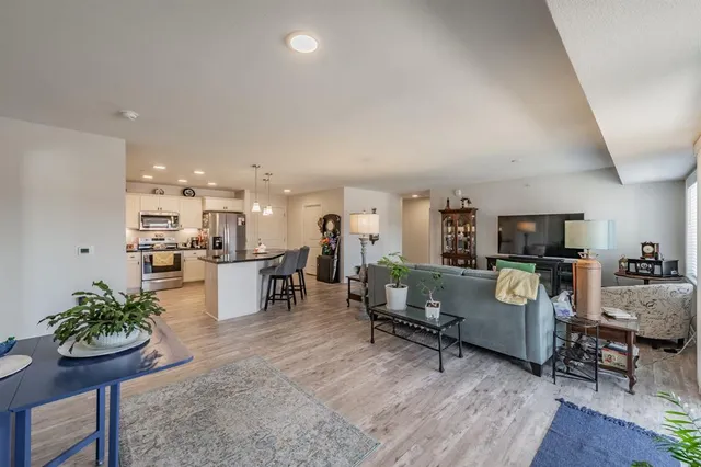 a kitchen with kitchen island a stove a table and chairs in it