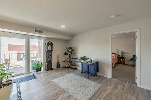 a view of balcony with chairs and wooden fence