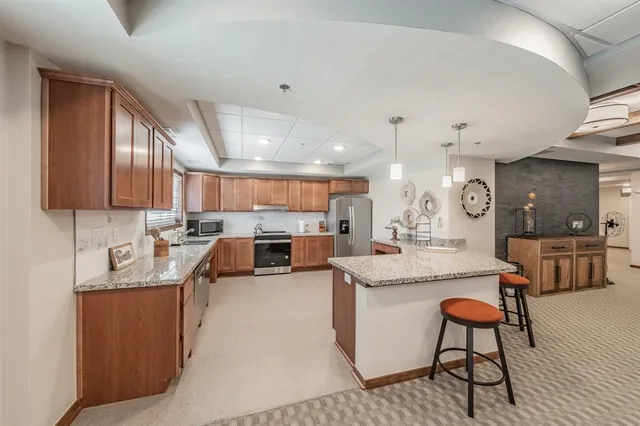 a large kitchen with a table and chairs