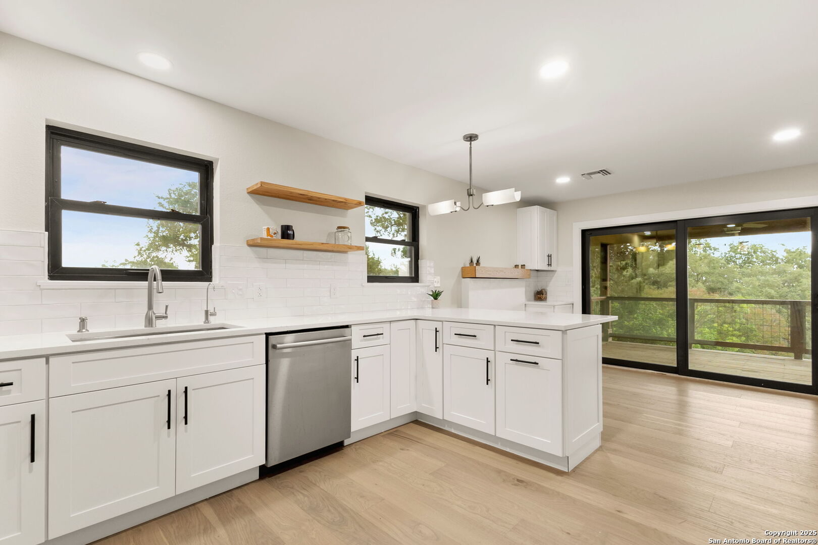 835 Fredericksburg Road New Braunfels, TX 78130 - Photo 18 of 56 a large white kitchen with a large window appliances and cabinets