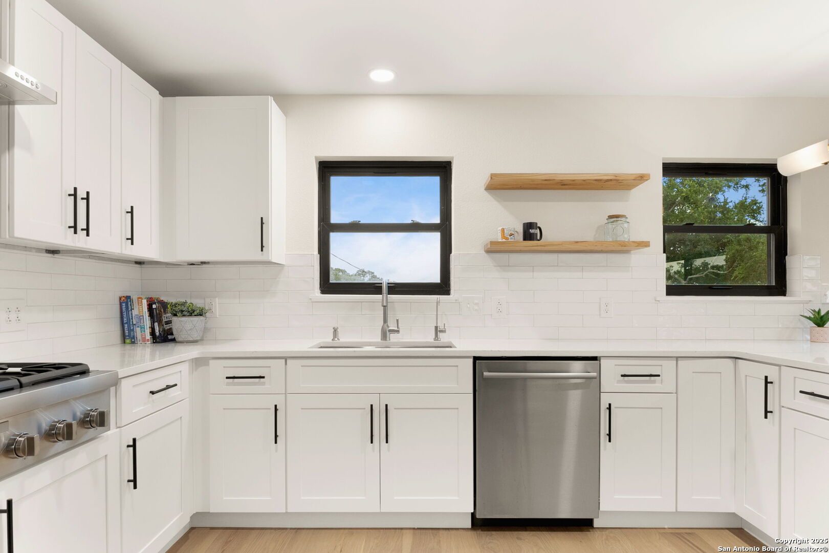 835 Fredericksburg Road New Braunfels, TX 78130 - Photo 19 of 56 a kitchen with white cabinets and sink