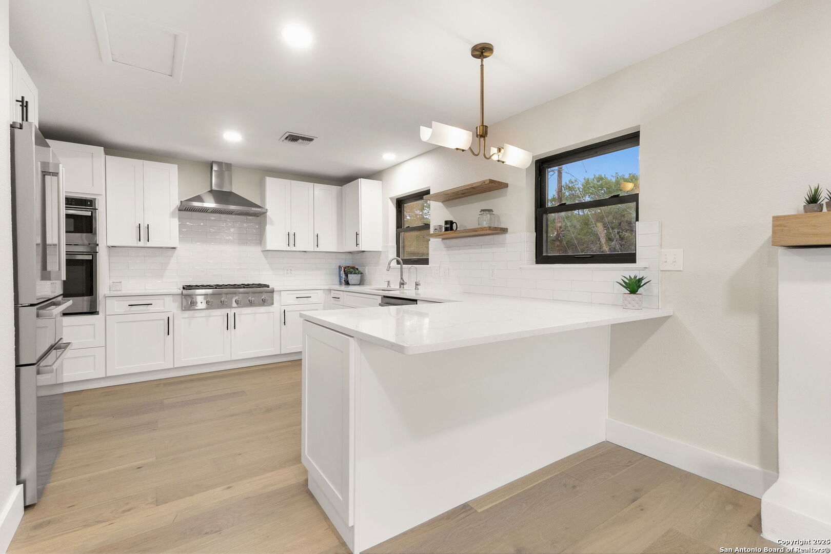 835 Fredericksburg Road New Braunfels, TX 78130 - Photo 21 of 56 a large kitchen with kitchen island a sink stainless steel appliances and cabinets