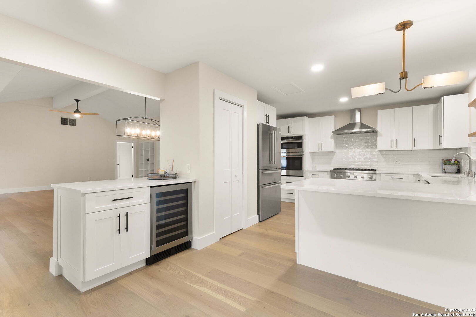835 Fredericksburg Road New Braunfels, TX 78130 - Photo 22 of 56 a kitchen with kitchen island a sink stainless steel appliances and white cabinets
