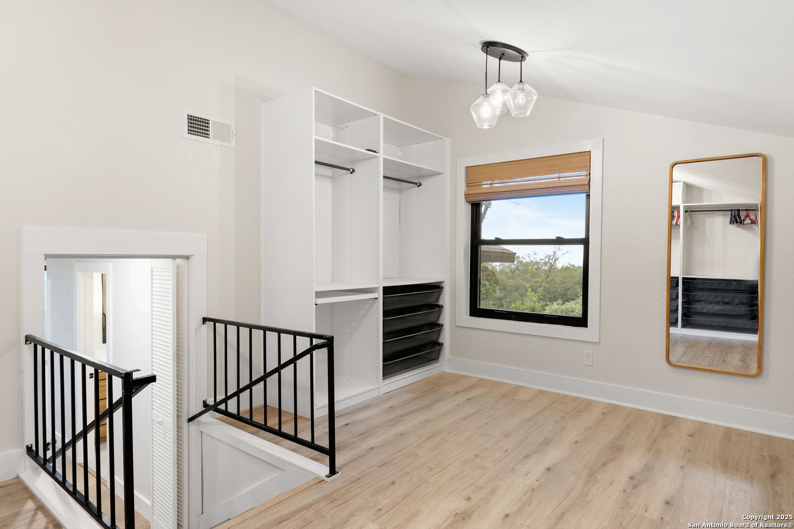835 Fredericksburg Road New Braunfels, TX 78130 - Photo 30 of 56 wooden floor chandelier and windows in a room