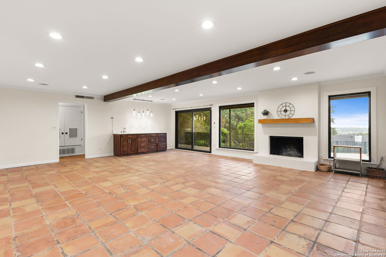 835 Fredericksburg Road New Braunfels, TX 78130 - Photo 32 of 56 a view of an empty room with a fireplace and a large window