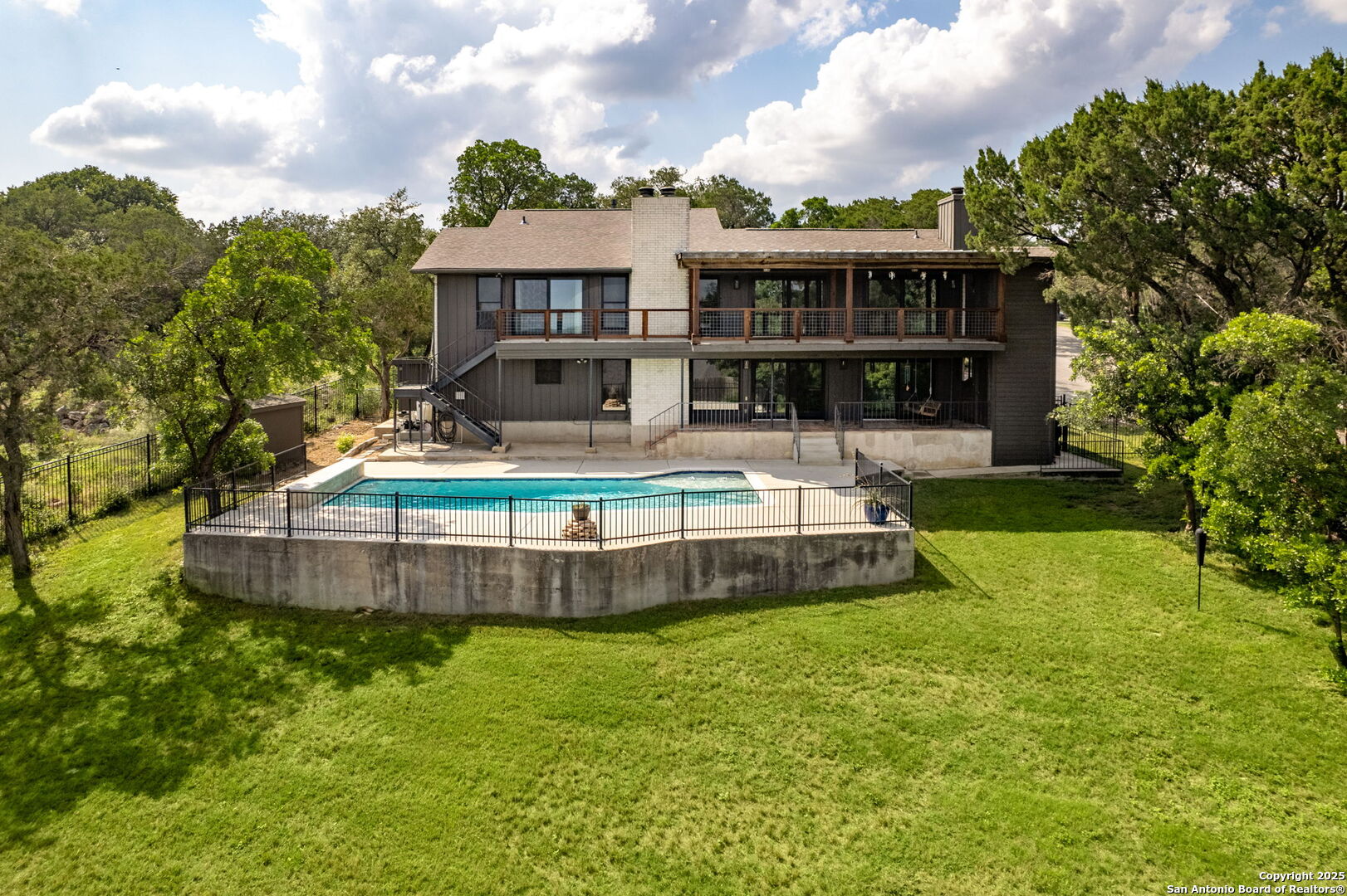 835 Fredericksburg Road New Braunfels, TX 78130 - Photo 50 of 56 a view of a house with a backyard and swimming pool